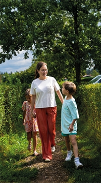 Sonniger Spaziergang mit Mutter und Kindern